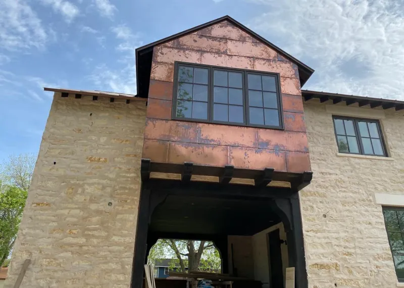 Copper metal panel facade on a stone building for Skylight Installation in Siesta Key